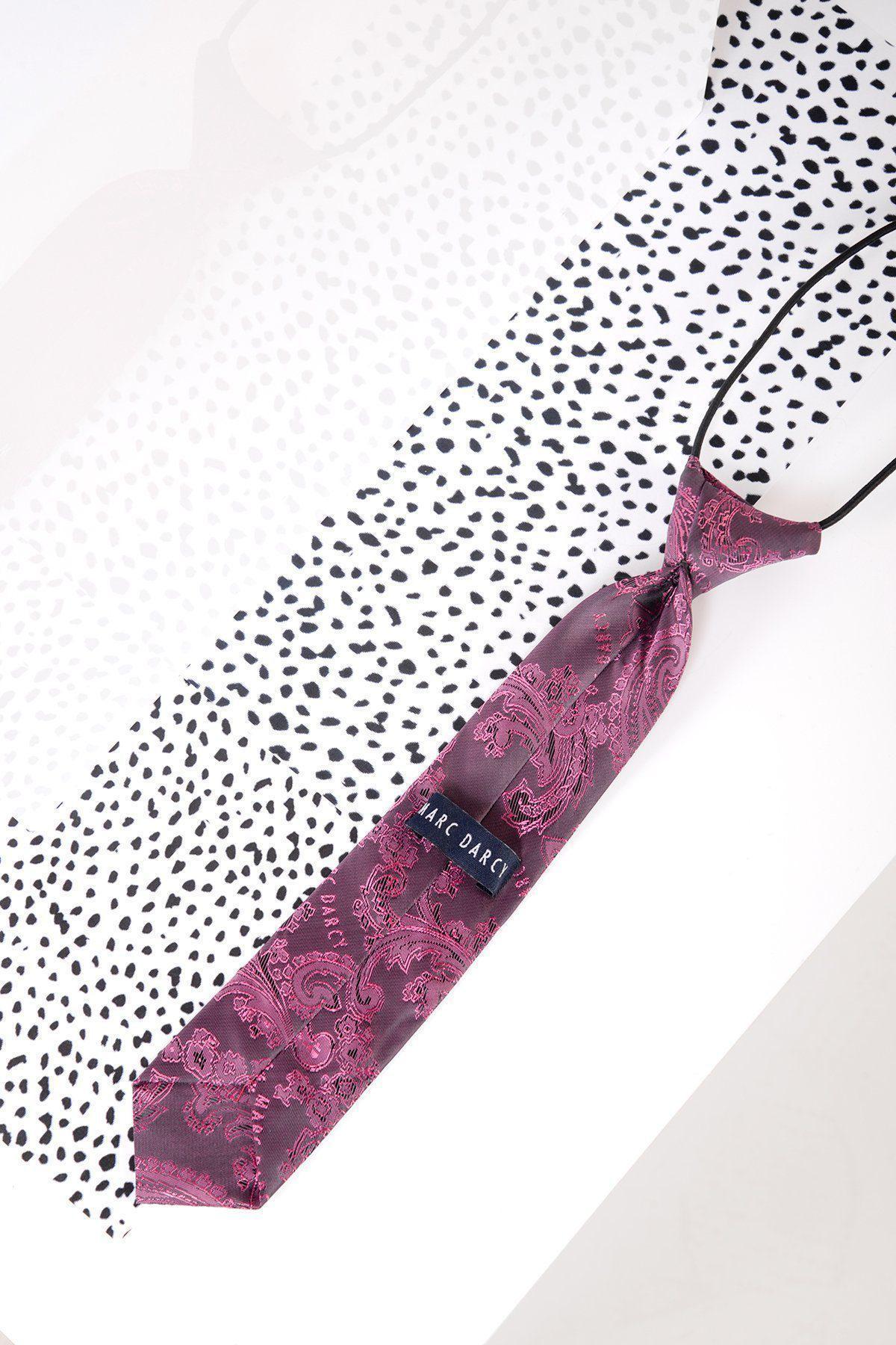 The Marc Darcy Childrens Berry Paisley Print Tie features an adjustable elasticated neck strap and lies on a white surface with black polka dots.