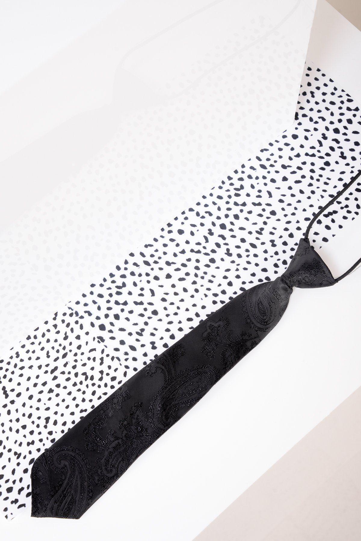 The Marc Darcy Children's Black Paisley Print Tie, pre-tied for convenience, features a subtle paisley pattern and is displayed on a white surface with black irregular dots for contrast.