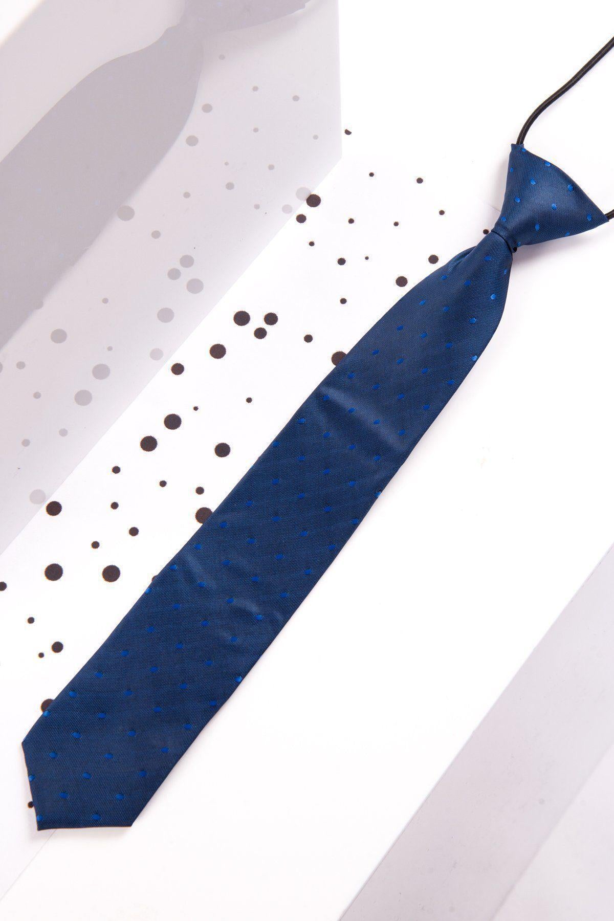 The Marc Darcy Children's Blue Polka Dot Print Tie, featuring small blue dots, is displayed on a white surface with black and gray scattered dots.