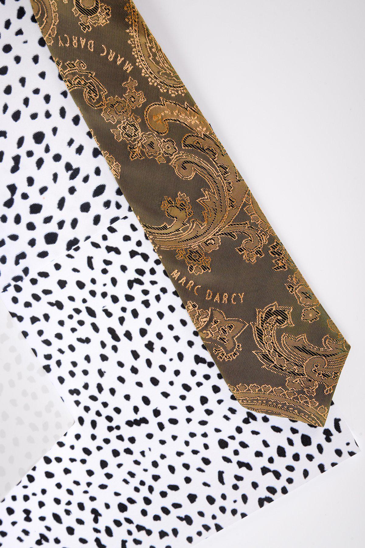 A Marc Darcy Children's Gold Tan Paisley Print Tie is displayed diagonally on a white background with black and grey animal-like spots.