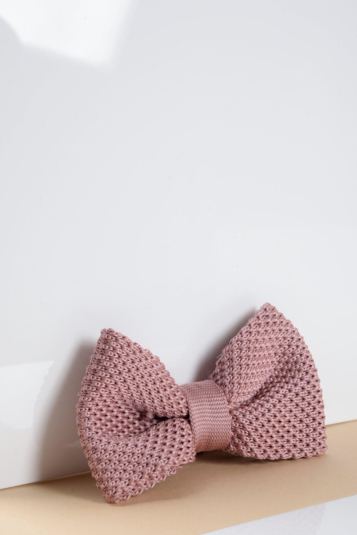 The Marc Darcy Childrens Knitted Bow Tie in Blush Pink, featuring an adjustable neck strap, is displayed on a white background with a soft shadow.