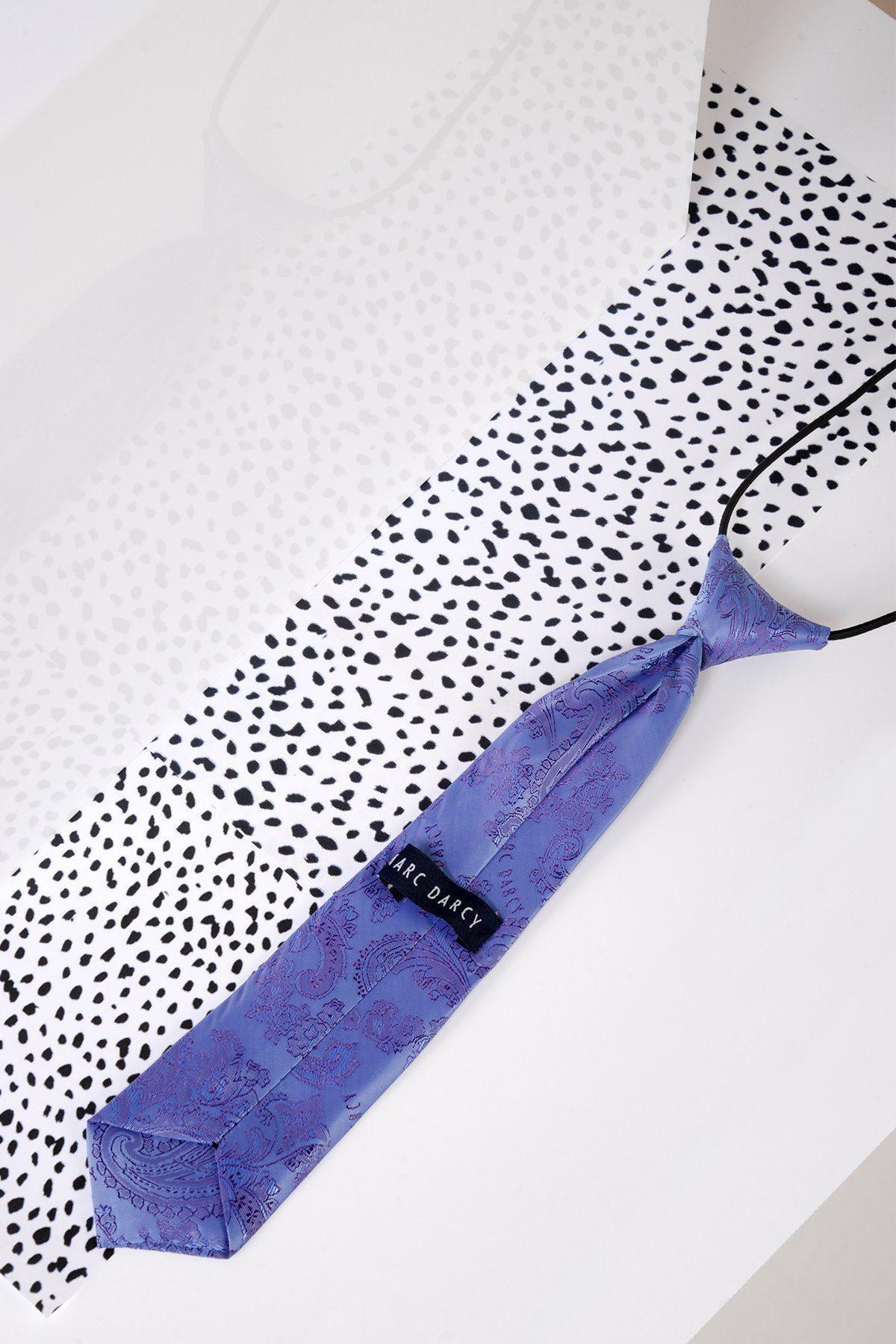 The Marc Darcy Childrens Lilac Paisley Print Tie, crafted from soft polyester with an adjustable neck strap, is displayed on a white surface with a black and white spotted pattern background.