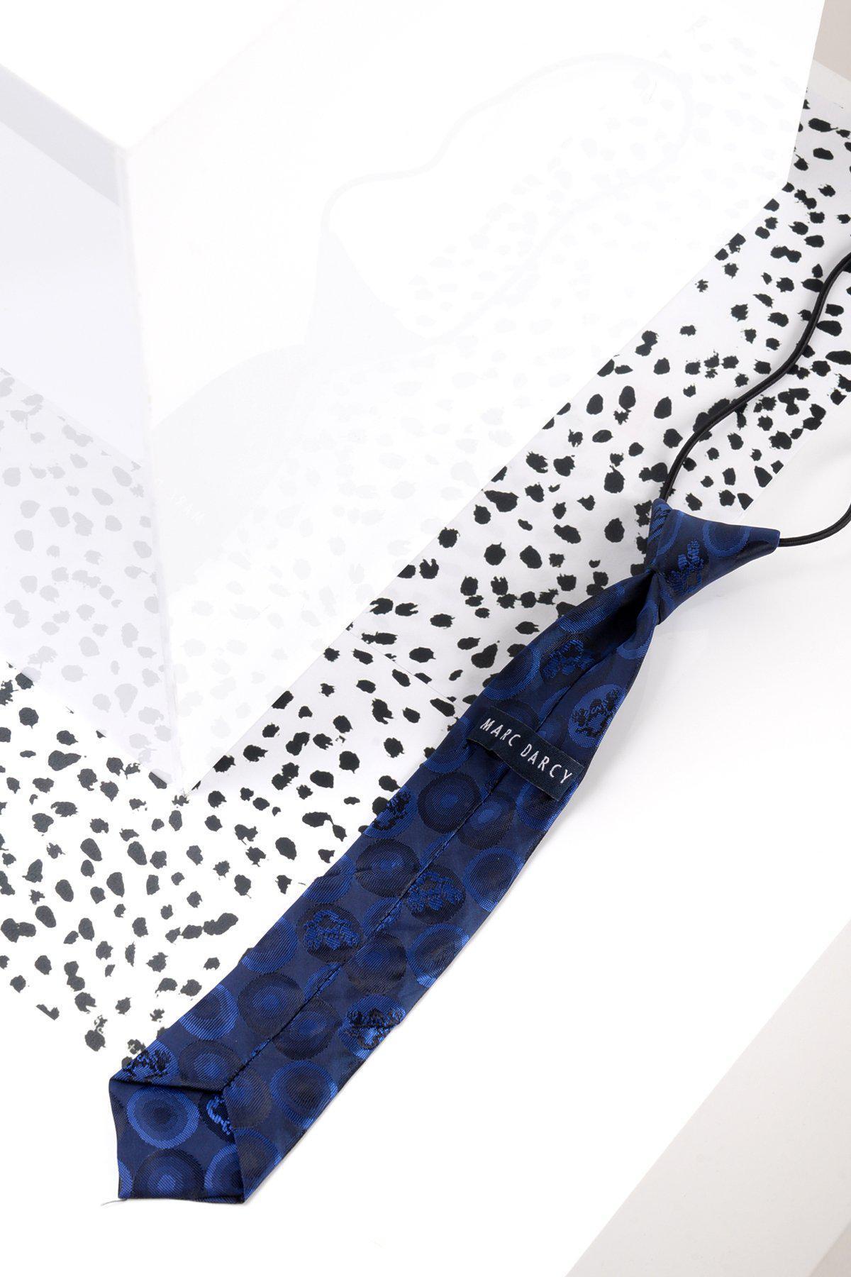 The Marc Darcy Childrens Navy Bubble Circle Print Tie is displayed on a white surface with black dots and abstract shapes, complemented by geometric backgrounds—perfect for finishing a boys suit.