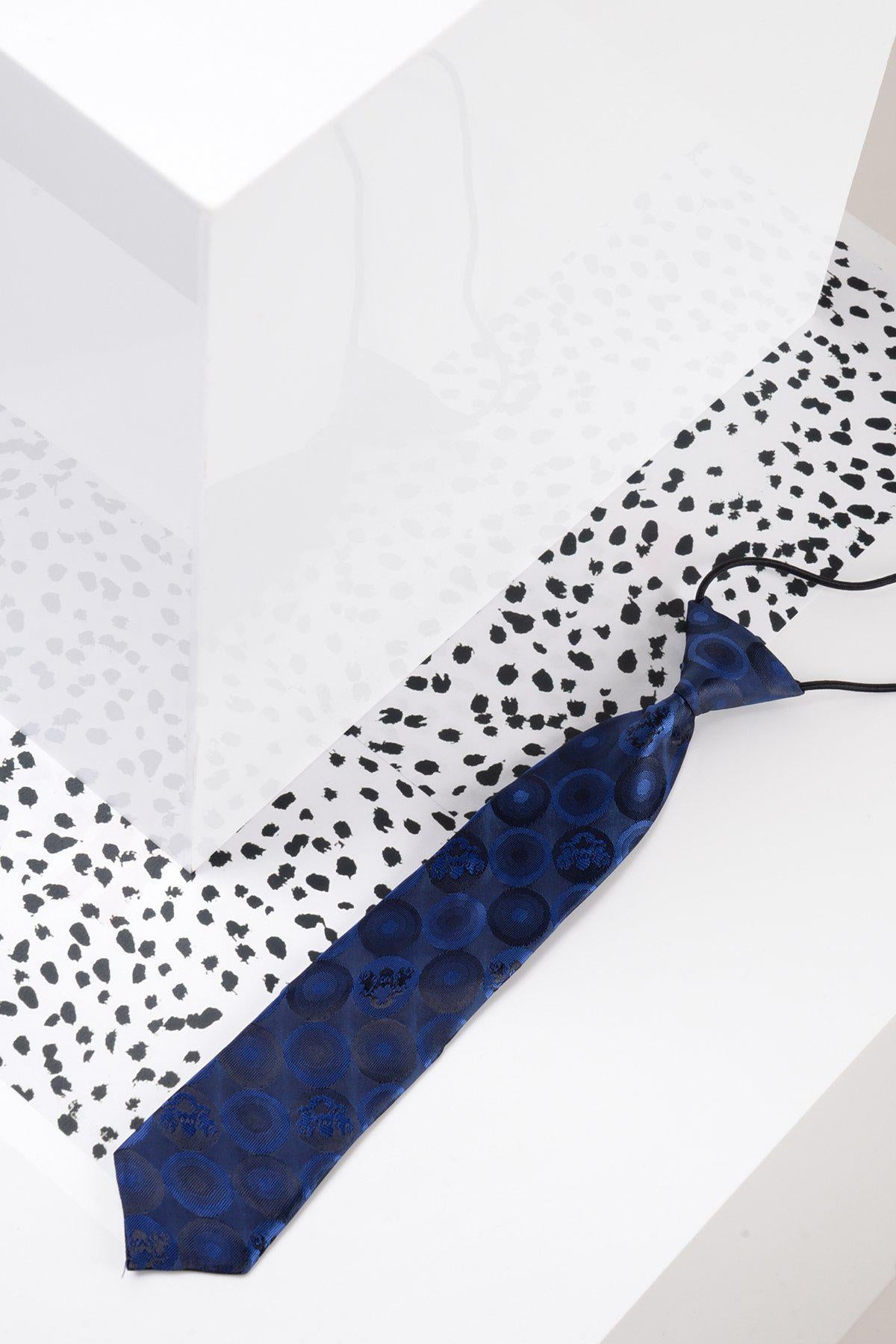 The Marc Darcy Children's Navy Bubble Circle Print Tie features a playful circular pattern—perfect for completing any boy's suit.