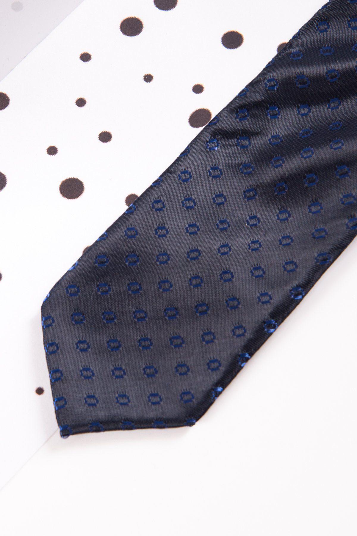 A close-up of the Marc Darcy Childrens Navy Spot Print Tie, featuring a dotted pattern and adjustable neck strap, displayed on a white surface with black polka dots.
