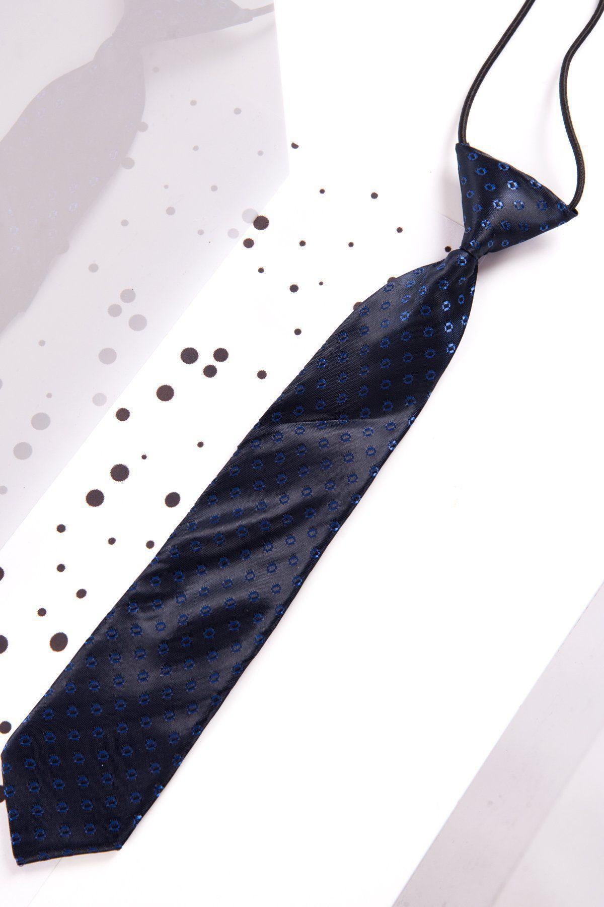 The Marc Darcy Childrens Navy Spot Print Tie features a pattern of small blue dots and an adjustable neck strap, making it perfect for special occasions. It is styled for a formal look and ideal as a childs tie.