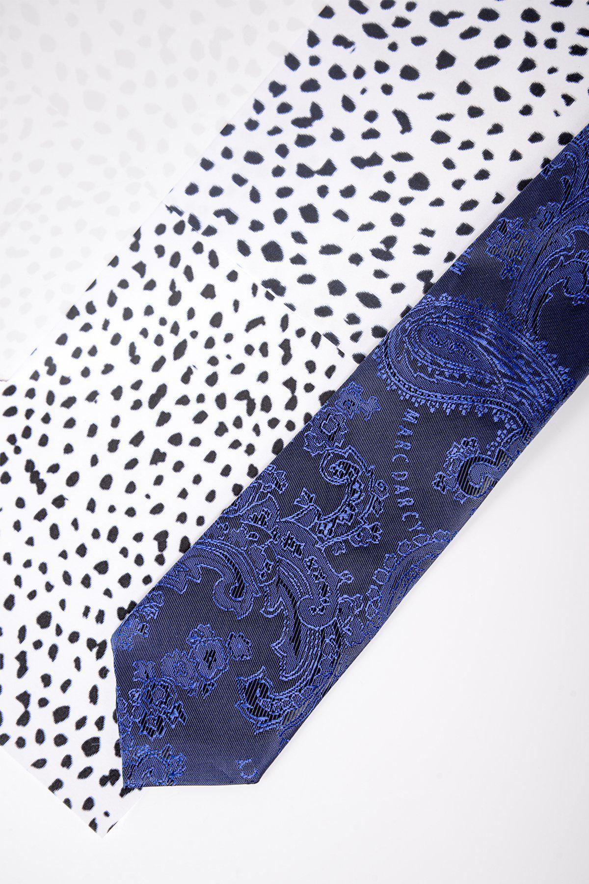 The Childrens Navy Paisley Print Tie by Marc Darcy features an intricate paisley design and is displayed diagonally on a white surface with a black gradient animal print.