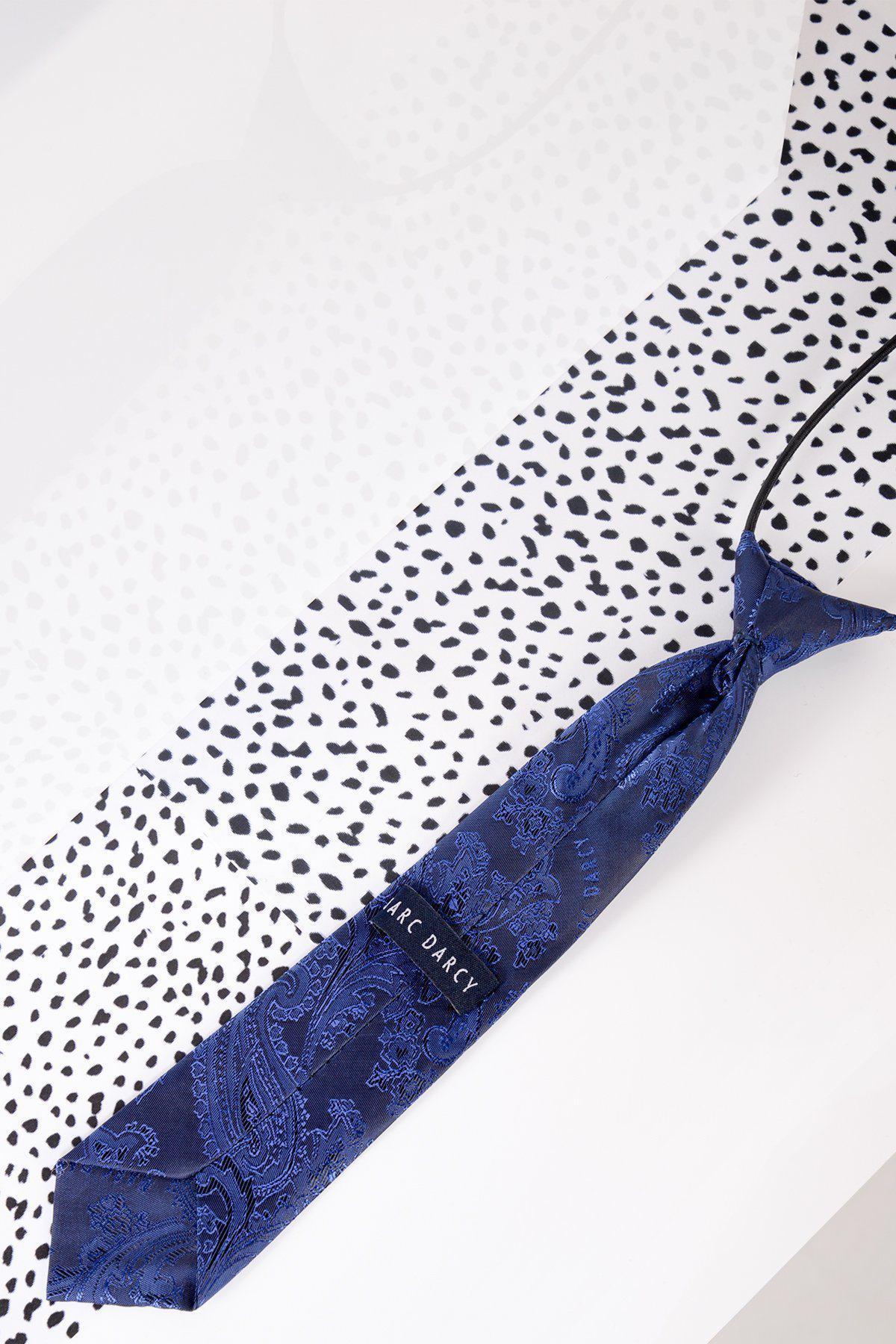 A Marc Darcy Childrens Navy Paisley Print Tie is displayed on a white surface featuring a black, irregular dot pattern.