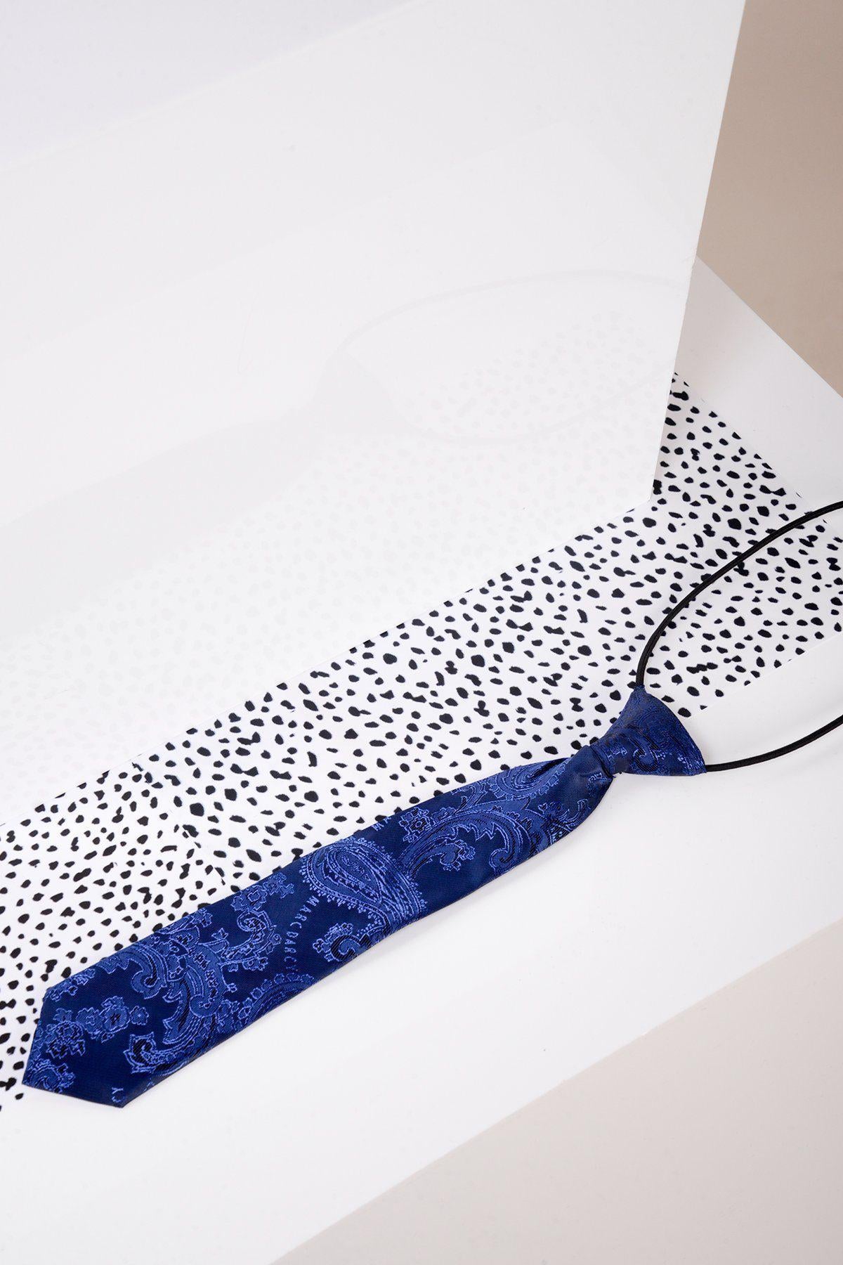 The Marc Darcy Childrens Navy Paisley Print Tie is shown on a white surface with black dots, featuring a pre-tied design and a black cord loop at the top.