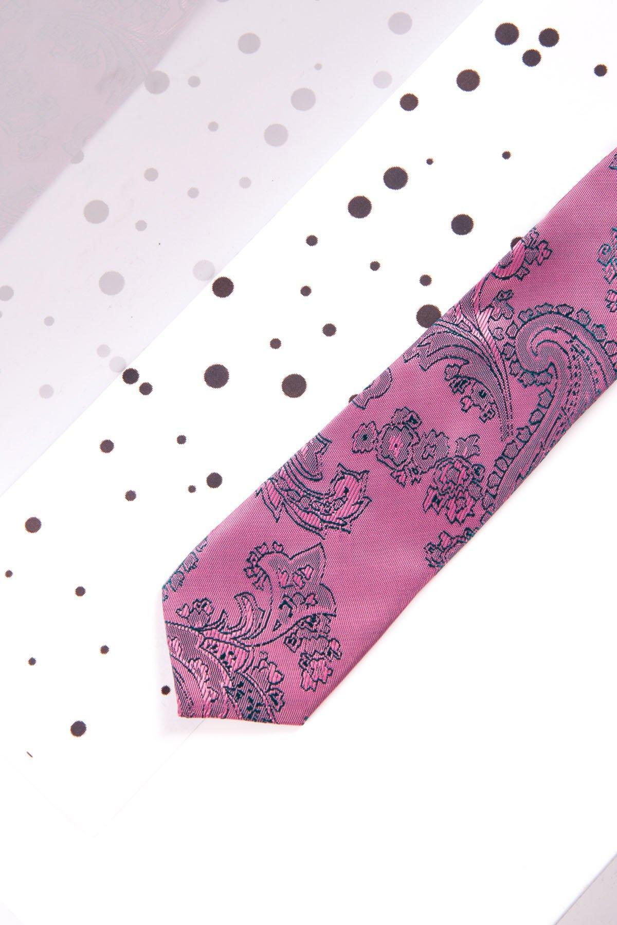 The Marc Darcy Childrens Pink Paisley Print Tie is displayed diagonally on a white surface with black dots, making it the perfect accessory to elevate any page boy suit or formal outfit.