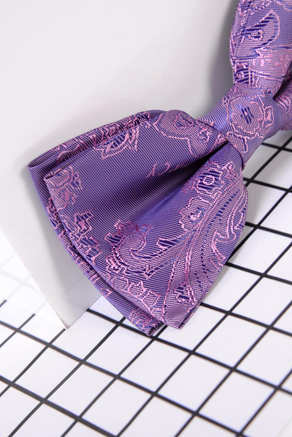 The Marc Darcy Children's Purple Paisley Print Bow Tie features a detailed paisley design and an adjustable neck strap, making it an ideal choice for boys' formalwear.