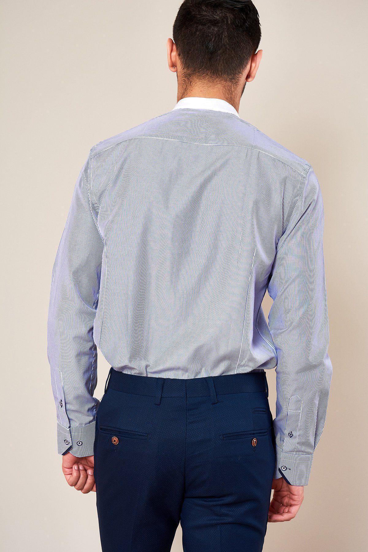 A man is seen from behind wearing the Marc Darcy COOPER - Grandad Collar Navy Stripe Shirt, tucked into dark blue dress pants, standing against a plain light-colored background.