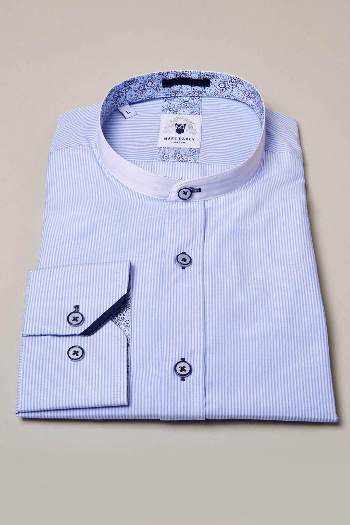 The COOPER Grandad Collar Sky Blue Stripe Shirt by Marc Darcy features light blue and white pinstripes, a mandarin collar, dark blue buttons, and patterned trim on the collar and cuffs.