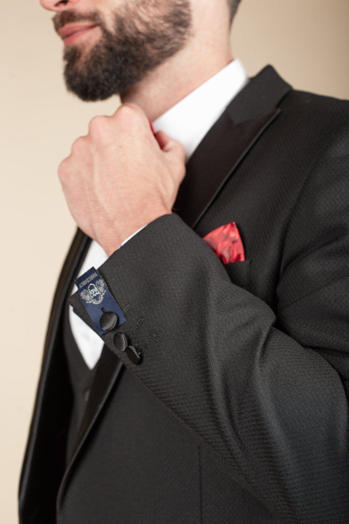 Boxing legend Frank Bruno wears the marcdarcy DALTON Black Tux Lapel Suit, styled with a red tie, white shirt, textured jacket, and red pocket square—an impeccable choice for black-tie occasions.