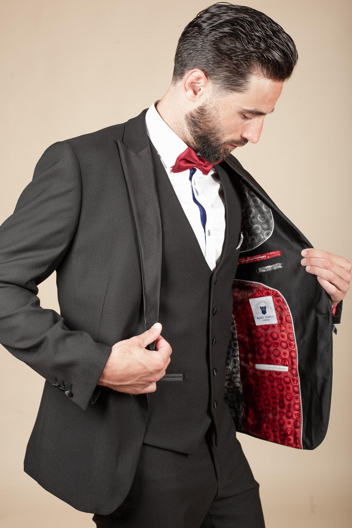 Owen Warner, 2022 runner-up of Im A Celebrity Get Me Out Of Here, wears the marcdarcy Dalton black tuxedo, revealing its stylish patterned lining—perfect for black tie events.