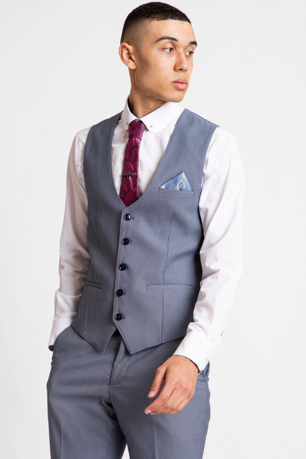 A young man models the Marc Darcy DANNY Blue Grey Single Breasted Waistcoat with matching trousers, white shirt, red patterned tie, and light blue pocket square—modern workwear style against a plain white background.