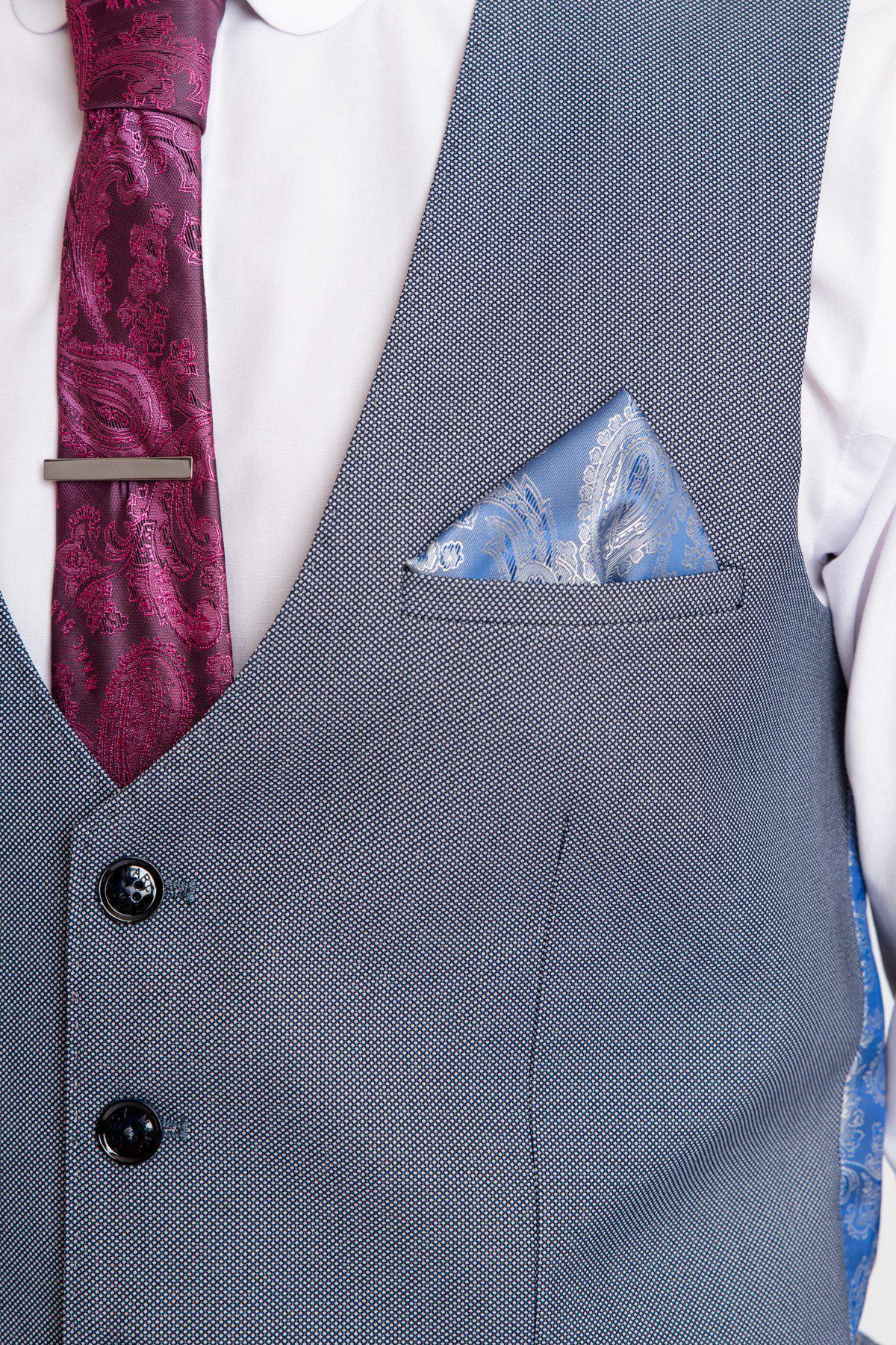 Close-up of a man wearing the Marc Darcy DANNY Blue Grey Single Breasted Waistcoat over a white shirt, styled with a burgundy paisley tie, silver tie bar, and a light blue paisley pocket square—a modern workwear essential.