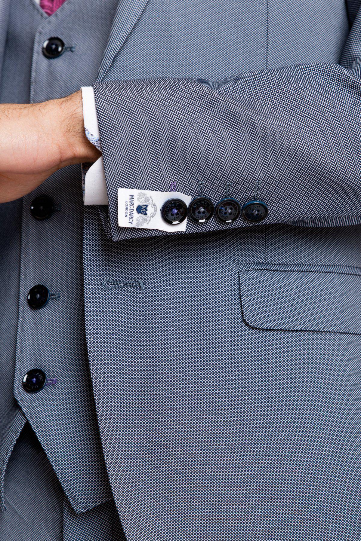 Close-up of the Marc Darcy DANNY Blue Grey Tailored Blazer, showcasing its textured fabric, lapel, buttons, and cuff with brand tag—ideal for modern workwear.