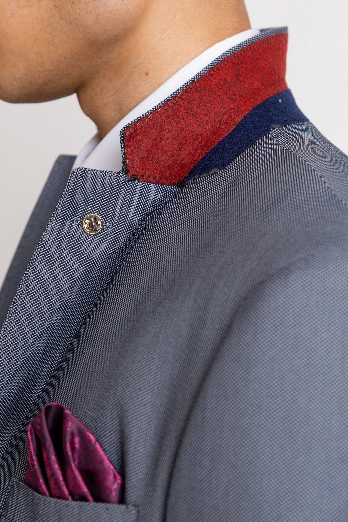 Close-up of a person wearing the Marc Darcy DANNY Blue Grey Tailored Blazer with red and navy collar detail, a white shirt underneath, and a purple pocket square in the breast pocket.