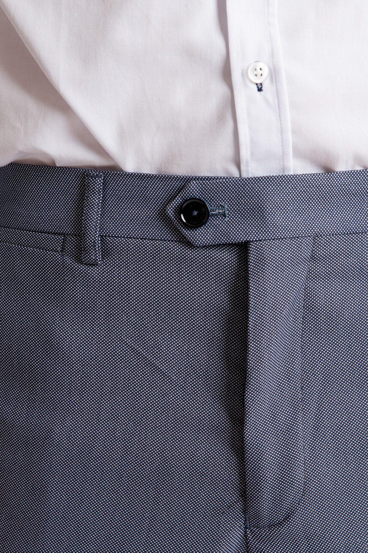 Close-up of a person wearing a white shirt tucked into Marc Darcys DANNY - Blue Grey Tailored Trousers, featuring a slim fit, belt loops, and black button.
