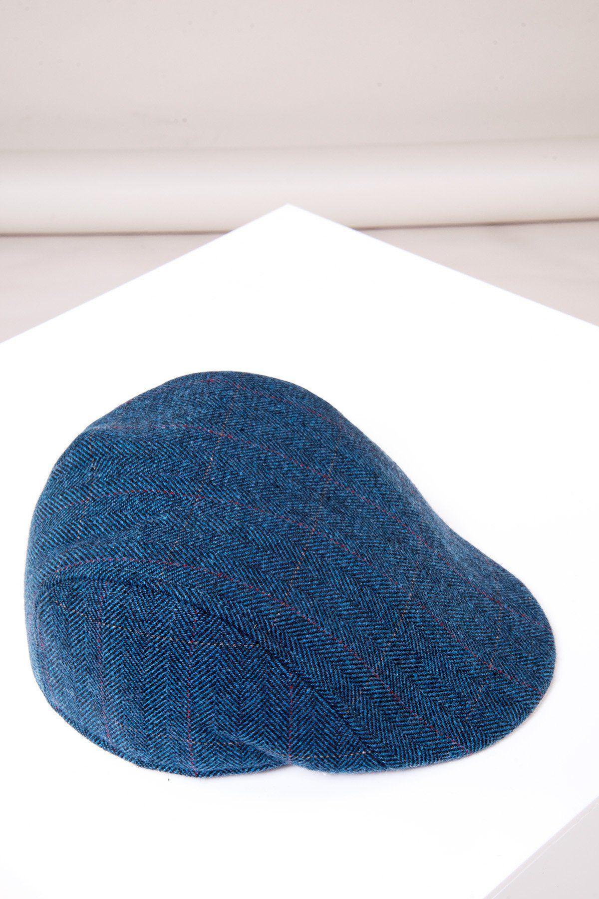 The DION - Blue Tweed Check Flat Cap by Accessory features a subtle herringbone pattern, displayed on a white surface with a plain background—perfect for adding vintage style to any outfit.