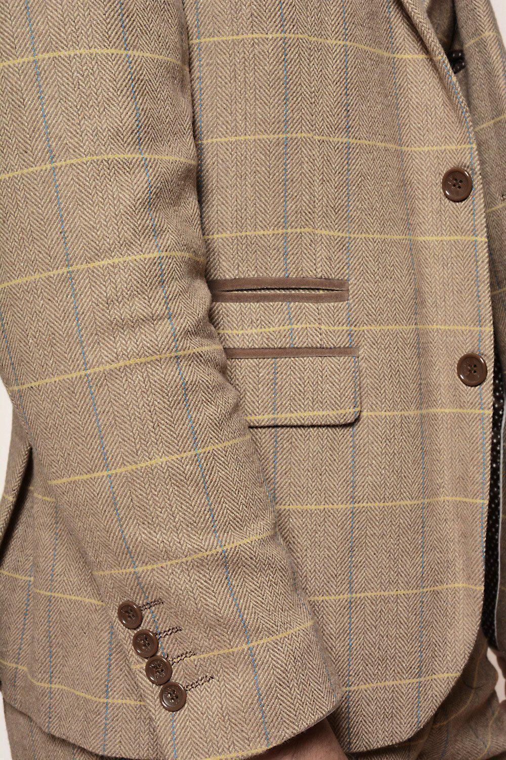 Close-up of the marcdarcy DX7 - Oak Tweed Check Blazer: tan herringbone tweed with yellow/blue windowpane checks, brown buttons, leather-trimmed welt pockets, and sleeve details—an elegant slim-fit classic.