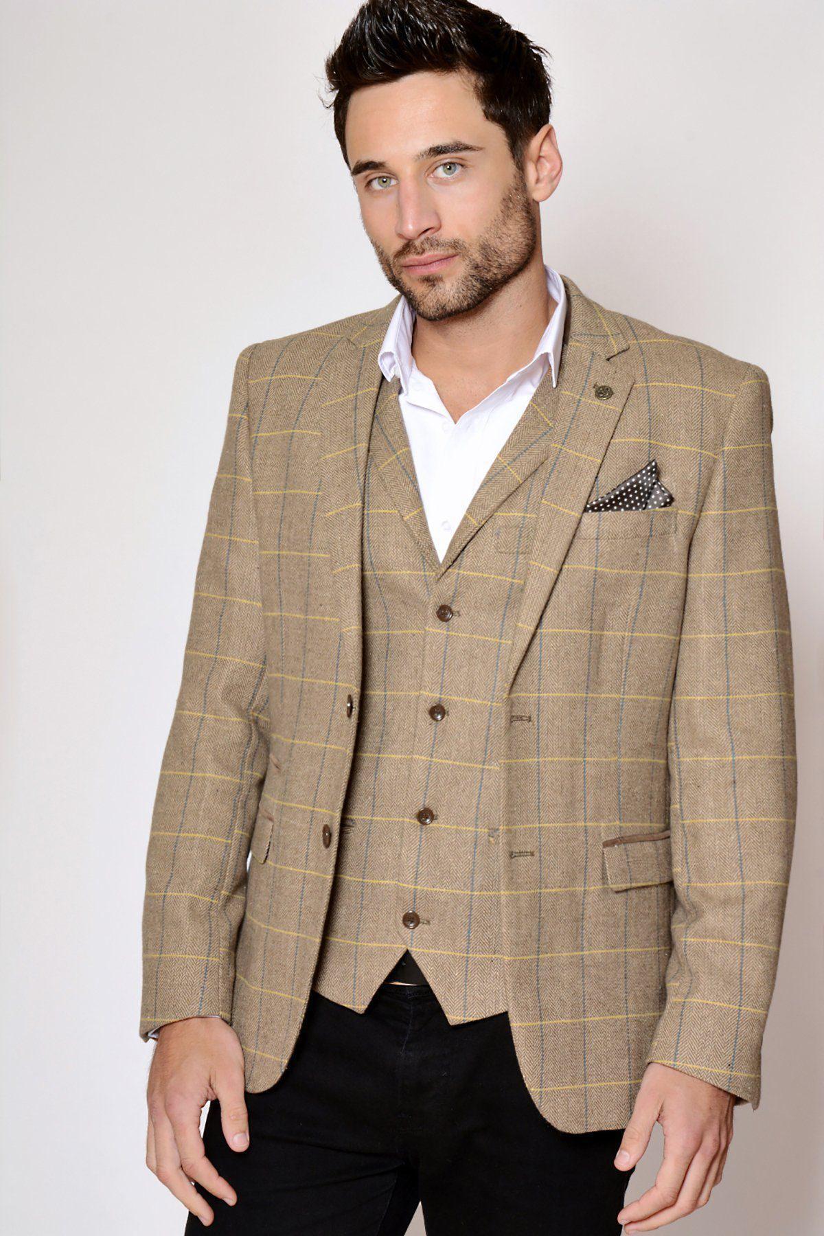 A man wears the marcdarcy DX7 - Oak Tweed Check Blazer in brown with a blue and yellow plaid, styled with a white shirt and a black pocket square.