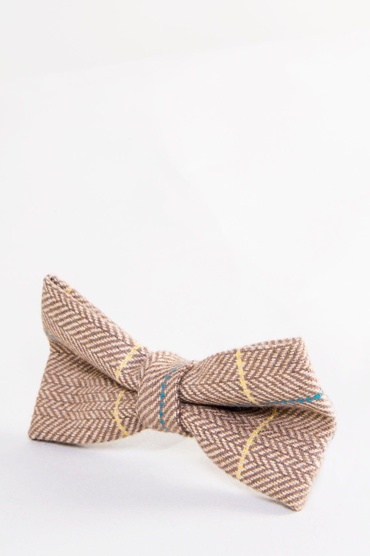 The Accessory DX7 - Oak Tweed Check Bow Tie features a brown herringbone pattern with yellow and blue lines, an adjustable strap, and is shown on a plain white background.