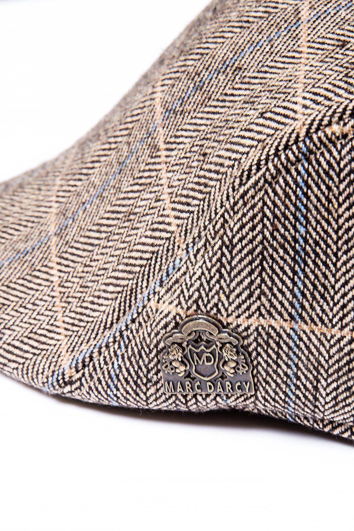 A close-up of the Accessory TED - Tan Tweed Check Flat Cap, featuring classic herringbone style with blue and white plaid accents and a metallic logo pin—a timeless piece for any country tweeds collection.