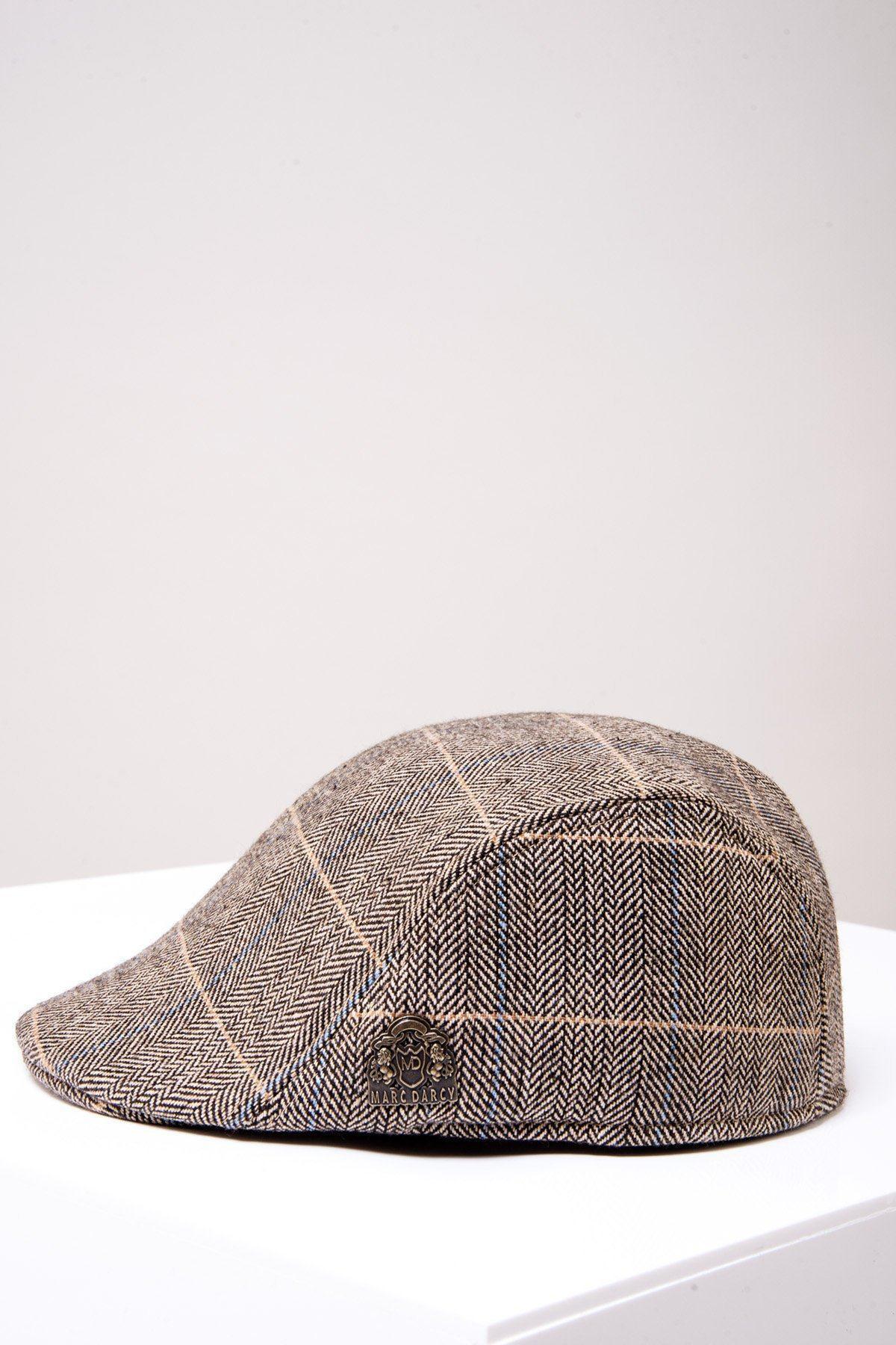 The Accessory TED Tan Tweed Check Flat Cap features a brown and tan plaid herringbone pattern with a small metal emblem on the side.