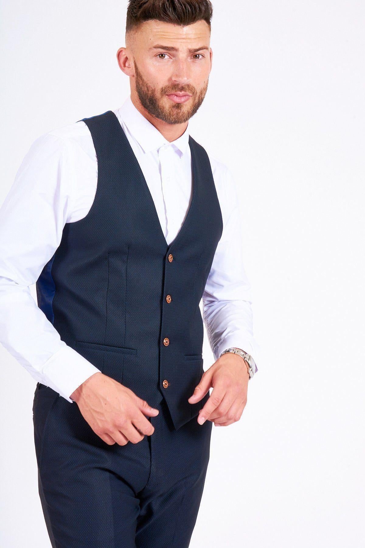 James Bye as Martin Fowler wears the marcdarcy Max Navy Suit—a slim fit, single-breasted style—paired with a white shirt, standing against a plain white background.