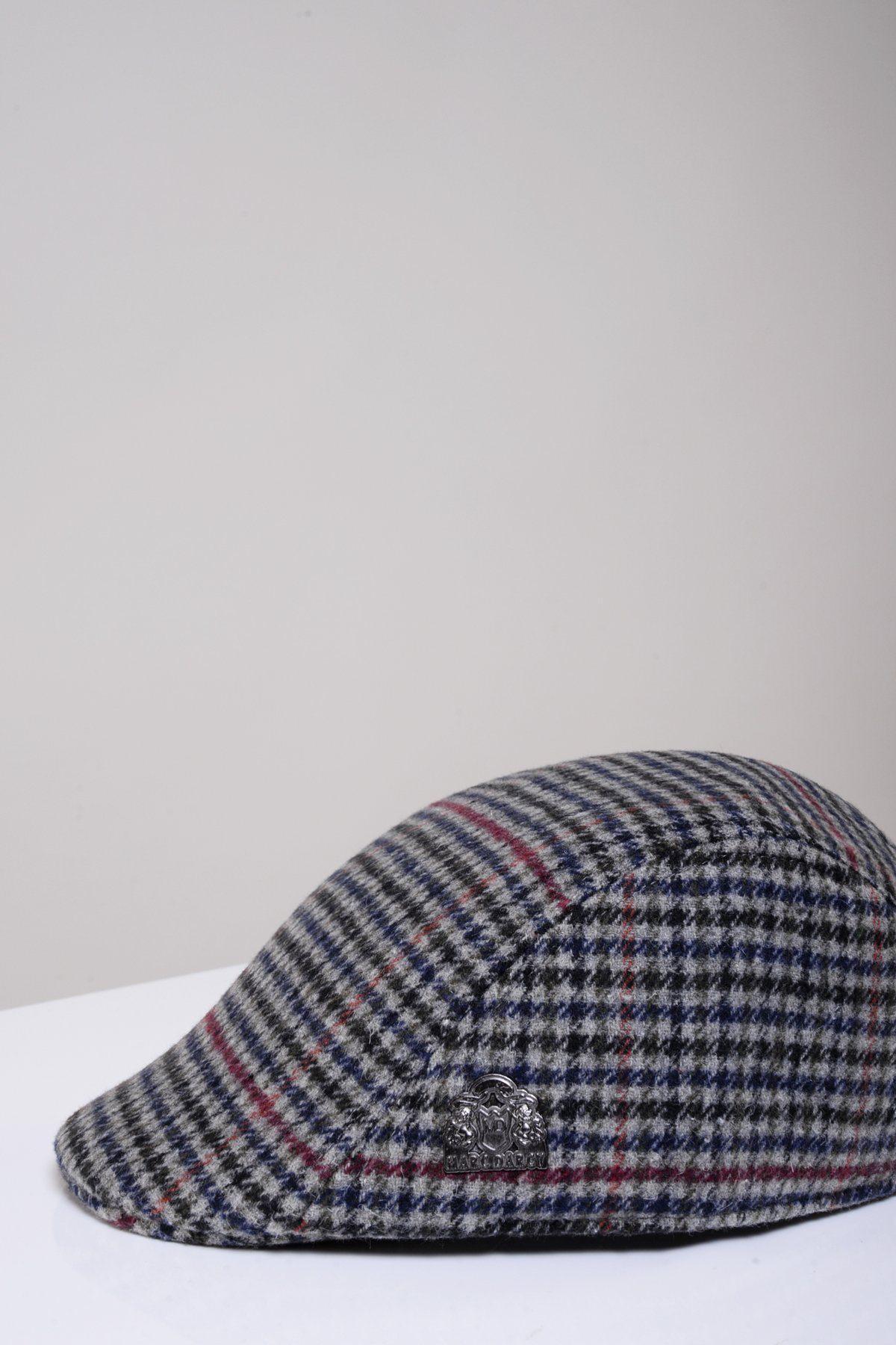 The EDWARD Navy Grey Check Tweed Flat Cap by Marc Darcy, featuring a classic plaid pattern and a small metallic emblem on the side, is displayed on a white surface against a light gray background.