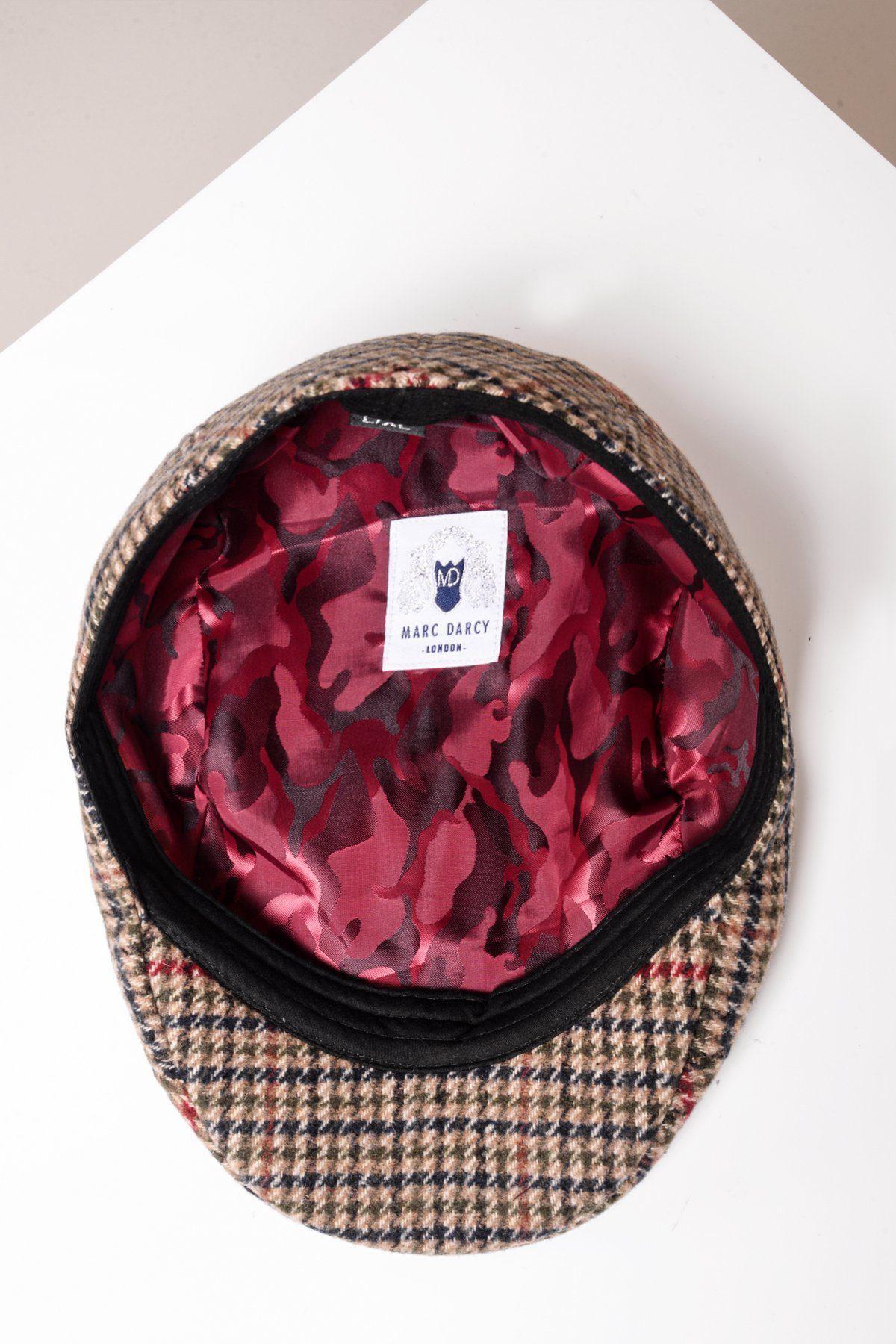 The EDWARD Olive Green Check Tweed Flat Cap by Marc Darcy features a stylish check pattern, a red camouflage-patterned inner lining, and a white label with the brand name and logo. The flat cap is elegantly displayed on a white surface.