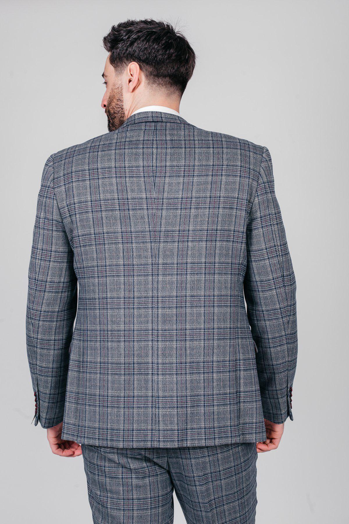 A man with dark hair and a beard is shown from the back, wearing the marcdarcy ENZO Blue Grey Tweed Check Blazer and matching trousers against a plain light gray background.