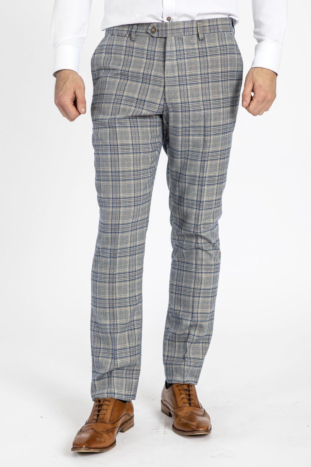 A man stands against a plain white background wearing a white shirt, marcdarcy ENZO - Sky Stone Check Tweed Trousers, and brown leather dress shoes.