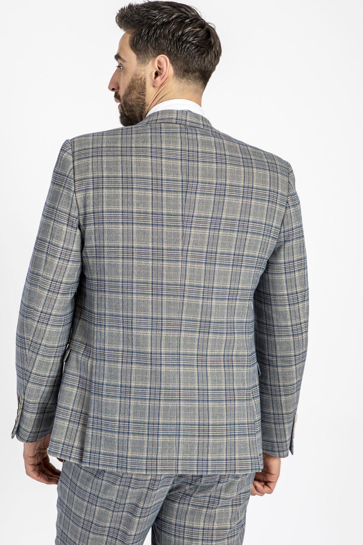 Man wearing a marcdarcy ENZO - Sky Stone Tweed Check Blazer, inspired by Peaky Blinders, with grey and blue Prince of Wales check pattern.