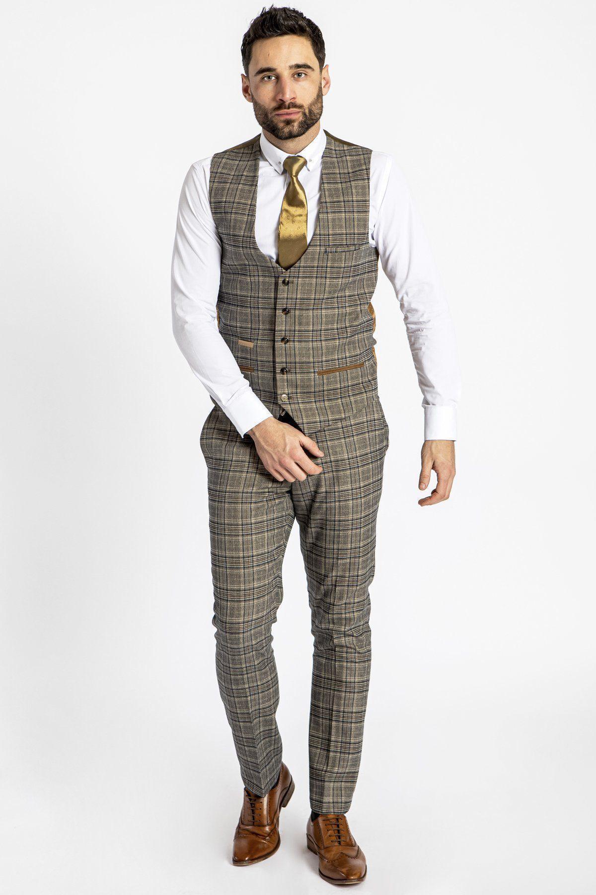 Man wearing a marcdarcy ENZO Tan Check Tweed Single Breasted Waistcoat and matching trousers, paired with a white shirt, gold tie, and tan Oxford shoes. Peaky Blinders inspired style on a white background.