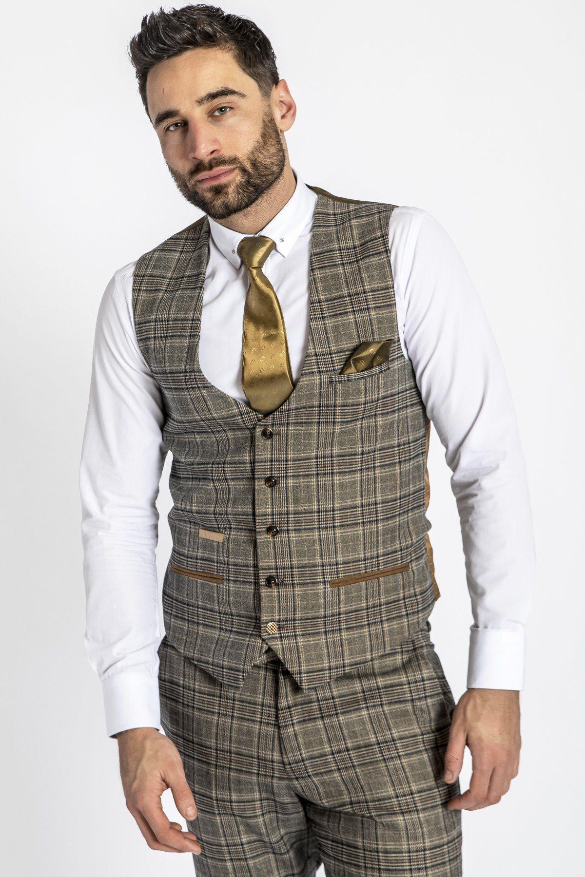 A man with short dark hair and a beard wears the marcdarcy ENZO Tan Check Tweed Single Breasted Waistcoat and matching trousers, paired with a white dress shirt and gold tie, standing against a plain white background.