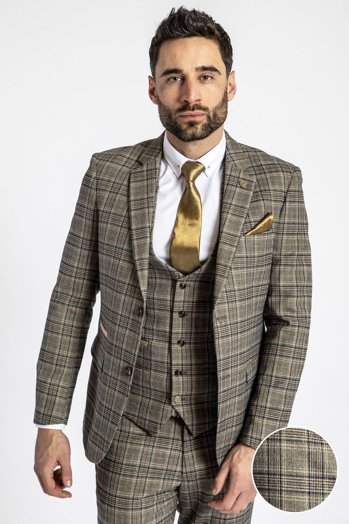 A man wears the marcdarcy ENZO Tan Tweed Check Blazer with a white shirt, gold tie, and matching pocket square. An inset displays a close-up of the check pattern. The background is plain white.