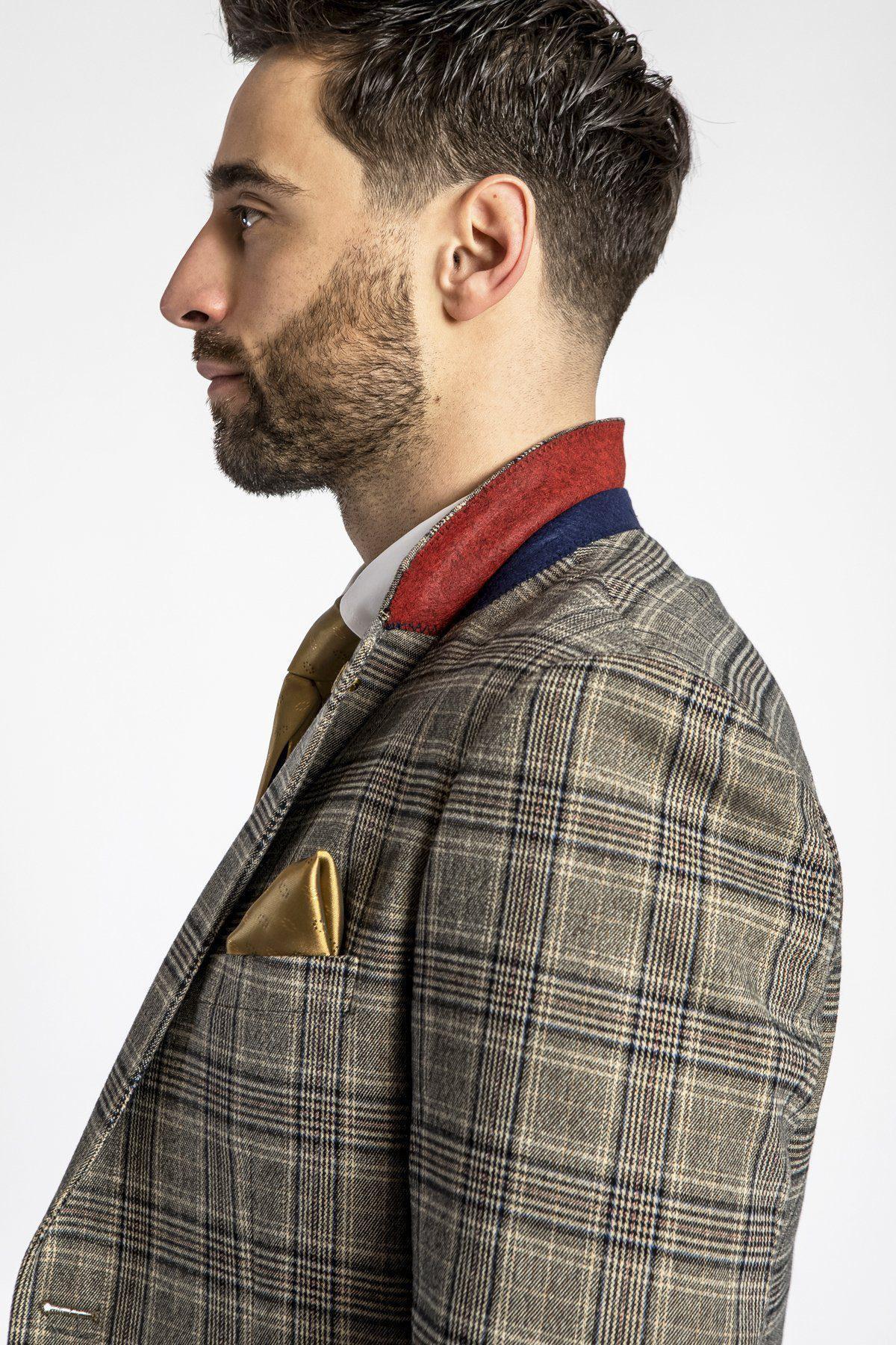 Side profile of a man wearing the marcdarcy ENZO - Tan Tweed Check Blazer with a red and blue collar, gold tie, and gold pocket square.