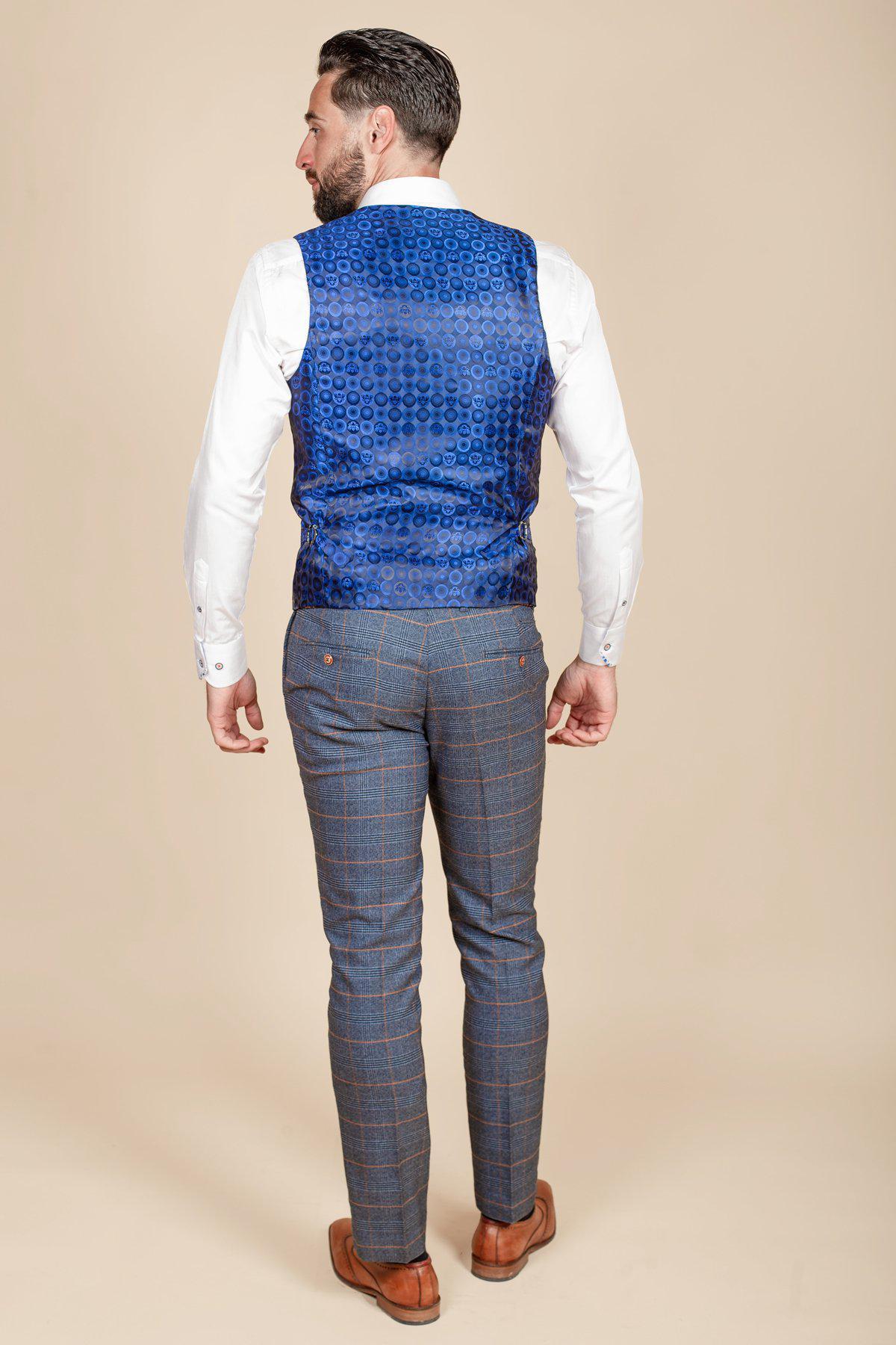 Former footballer Clinton Morrison wears the marcdarcy Jenson sky blue check suit against a beige backdrop.