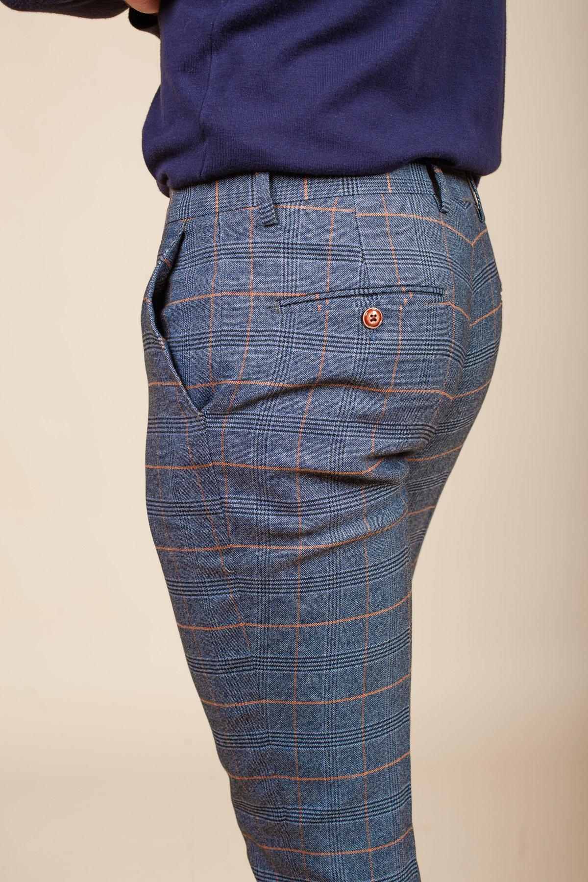 Former footballer Clinton Morrison wears the marcdarcy Jenson Sky Blue Check Suit, shown from the waist down and turned slightly to the side against a plain beige background.