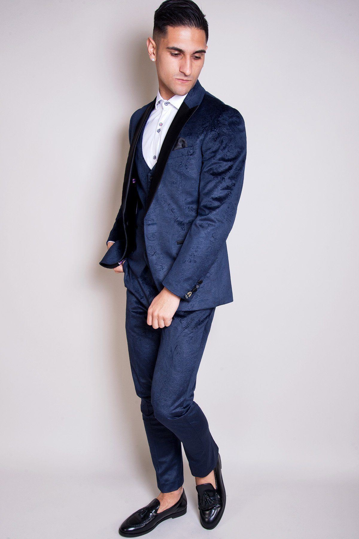 Will Mellor (as Harvey Gaskell in Coronation Street) wears a Marc Darcy Simon velvet blazer and waistcoat, styled with a crisp white shirt and black loafers for a sharp tailored look.
