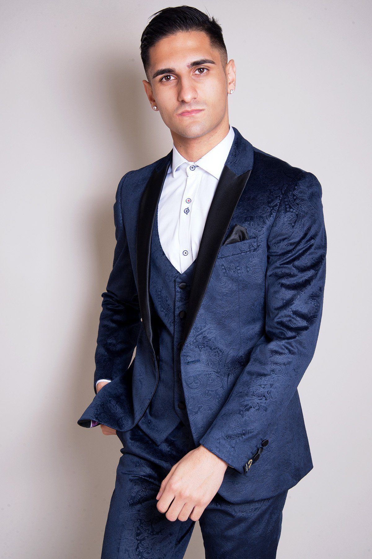 Will Mellor (Harvey Gaskell from Coronation Street) wears a Marc Darcy Simon velvet blazer and waistcoat, paired with a white shirt, standing confidently against a plain light background.