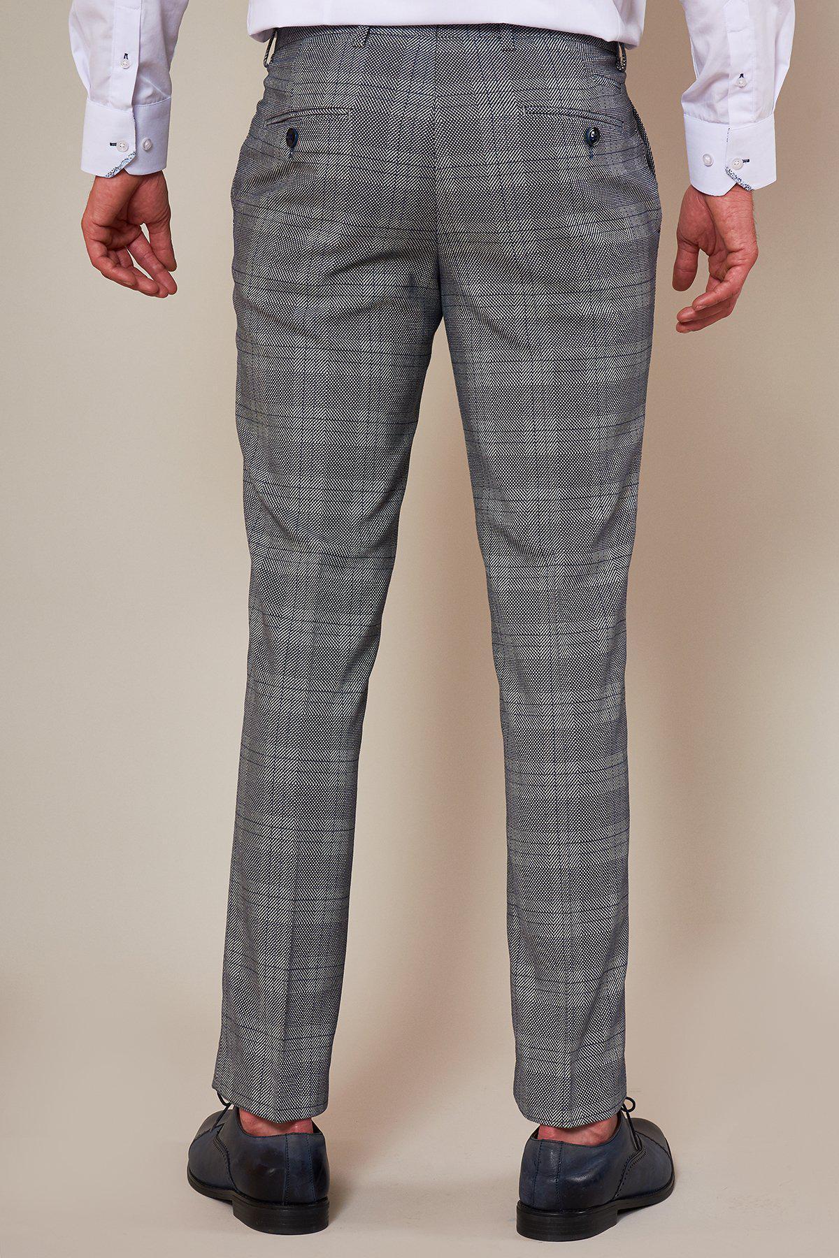 A person in the marcdarcy Sheffield Utd Collection, Oliver Norwood Jerry Check Suit, with a white shirt and black shoes, is shown from the back against a plain background.