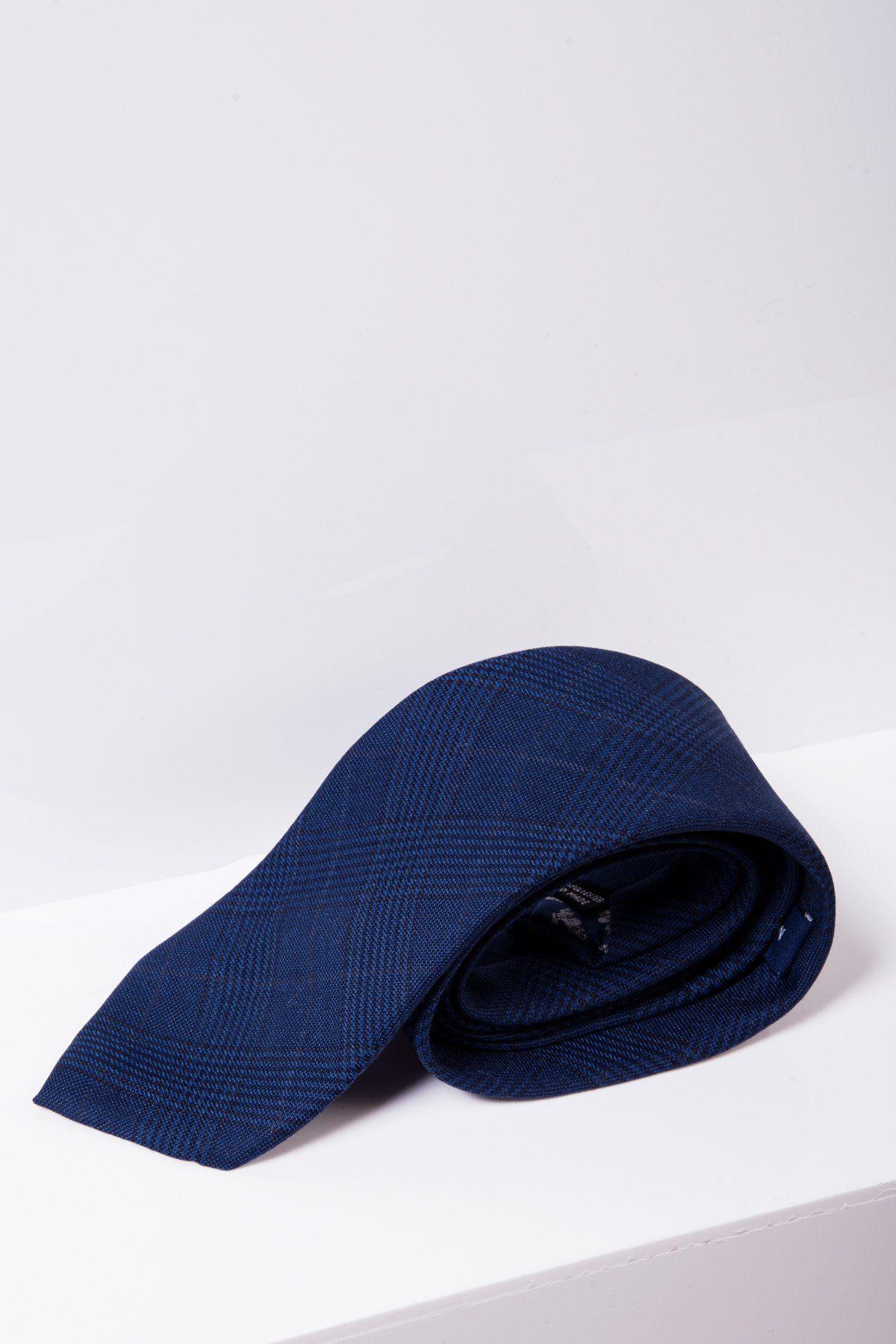 The GEORGE - Royal Blue Check Tie by Accessory, featuring a subtle Prince of Wales check, is rolled up and displayed on a white surface with a plain white background.