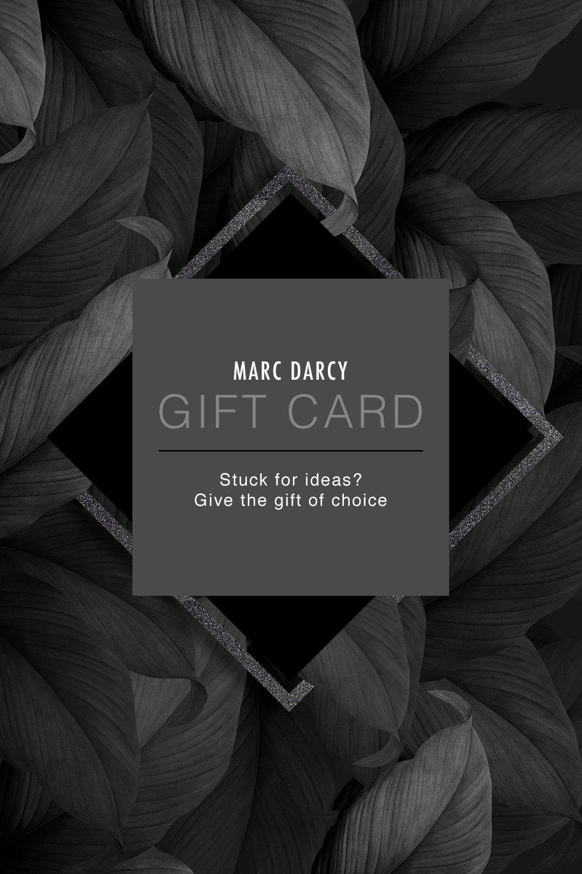 Marc Darcy Gift Card – the perfect gift of choice. Features a dark, leafy background with a grey diamond-shaped overlay and text.