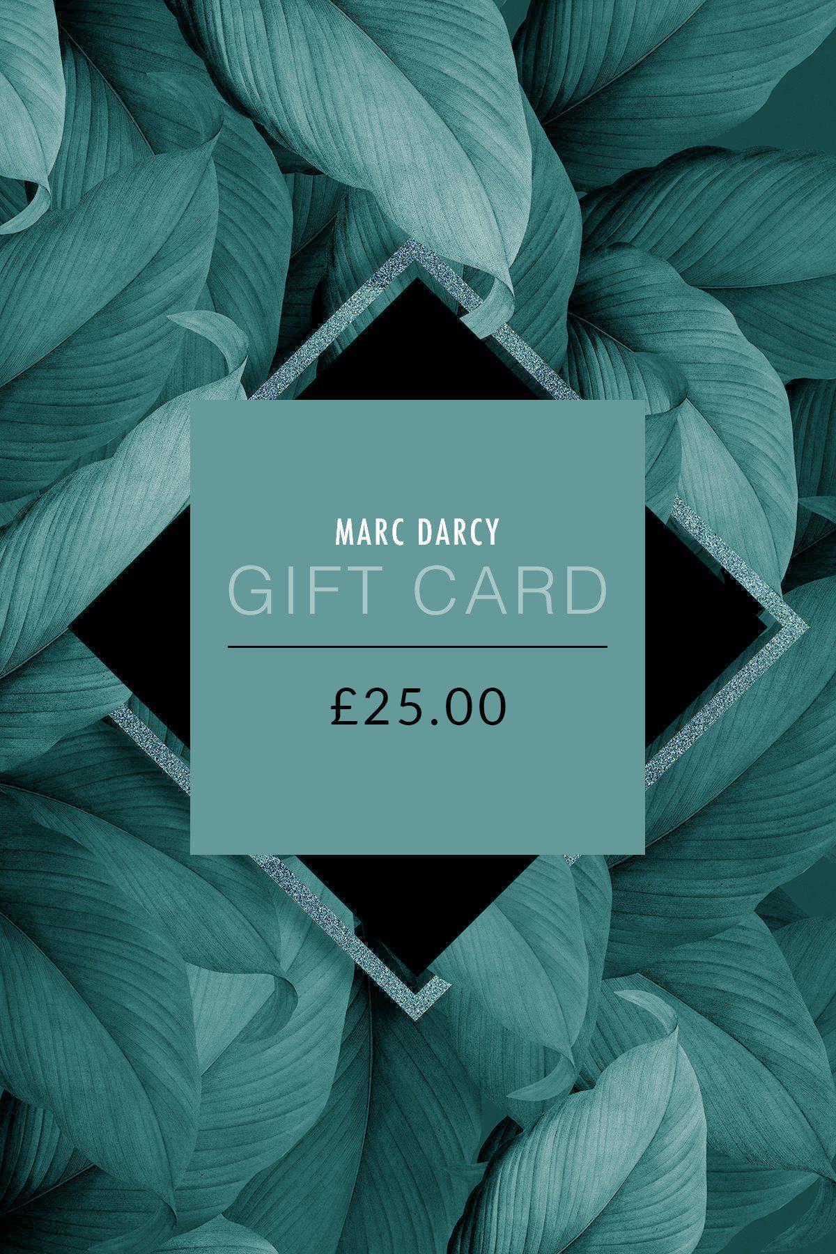 A Marc Darcy Gift Card - £25.00 in green and black is centered over bold, overlapping green leaves—the ideal present to redeem stylish menswear at checkout.