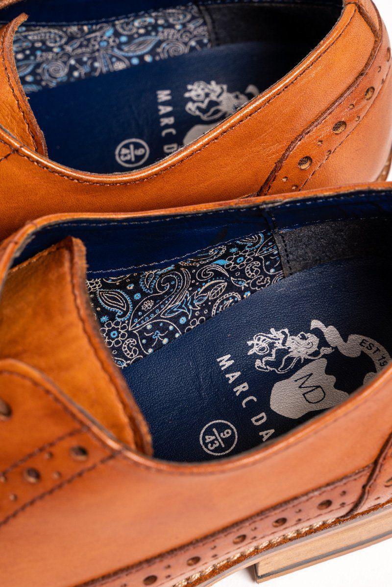 Close-up of the GRAYSON Tan Leather Wingtip Brogue Shoe by Marc Darcy, highlighting blue insoles with a white paisley pattern, size markings, and decorative stitching with perforations on handcrafted full grain leather.