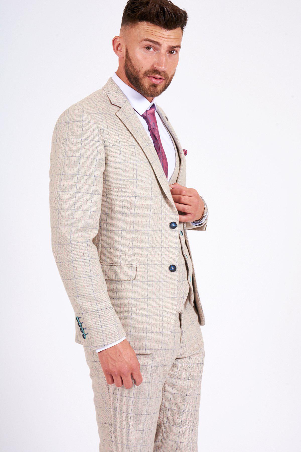 A man with short brown hair and a trimmed beard wears the marcdarcy HARDING Cream Tweed Check Print Blazer with a white shirt and mauve tie, posing confidently against a plain white background—a sharp spring style statement.